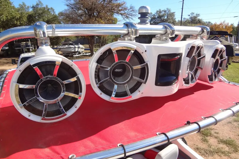 Slide: The Image of 2003 Ski Centurion Tsunami boat with large speakers on a red cover. - 28