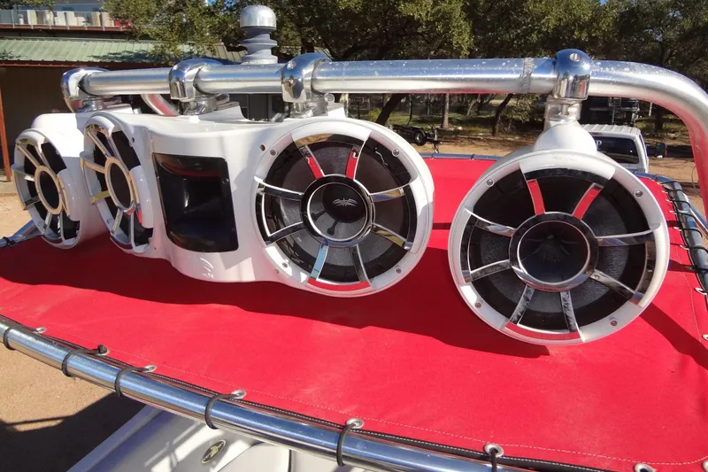 Slide: The Image of 2003 Ski Centurion Tsunami boat speakers on red cover, outdoor setting. - 29