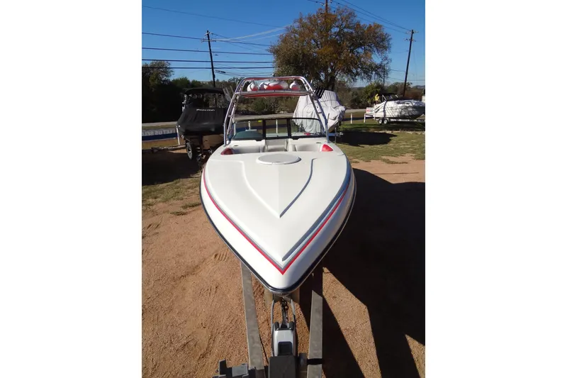 Slide: The Image of 2003 Ski Centurion Tsunami boat on trailer, parked outdoors, clear sky background. - 9