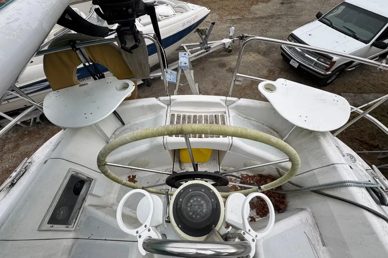 Slide: The Image of Cockpit view of a 1992 Hunter 33.5 sailboat with steering wheel and compass. - 10