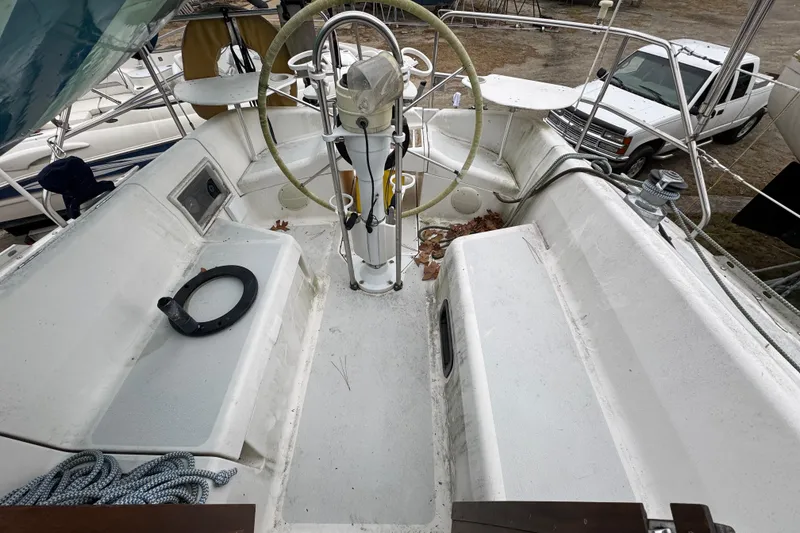 Slide: The Image of Cockpit of a 1992 Hunter 33.5 sailboat with steering wheel and seating. - 11