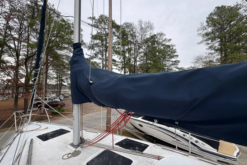 Slide: The Image of Sailboat deck of 1992 Hunter 33.5 with covered boom, docked near trees. - 15