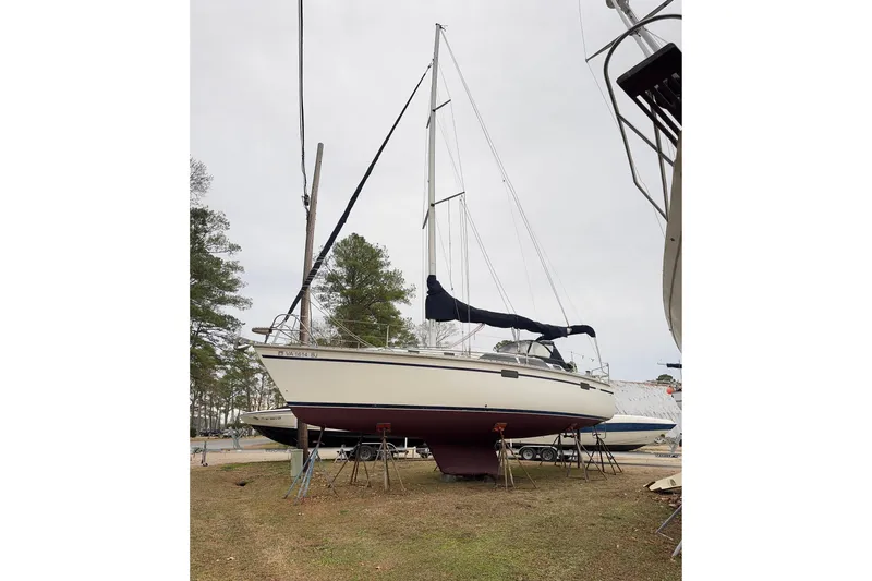Slide: The Image of 1992 Hunter 33.5 sailboat on stands, ready for maintenance in a boatyard. - 2