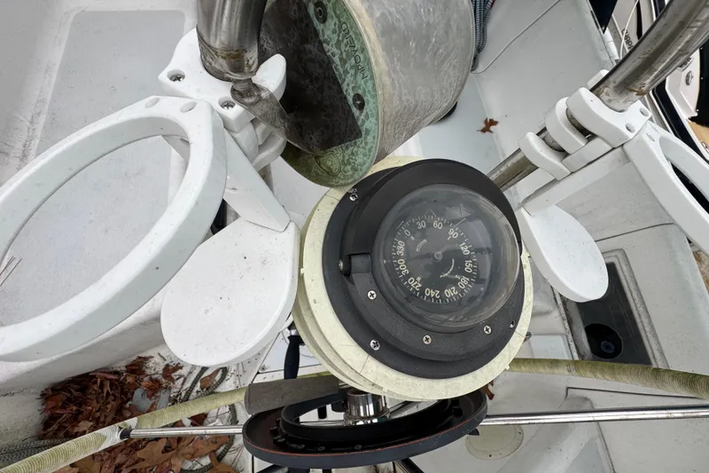 Slide: The Image of Compass on 1992 Hunter 33.5 sailboat cockpit, surrounded by white fittings. - 28