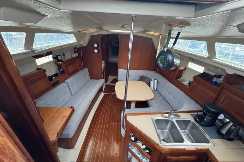 Slide: The Image of Interior of a 1992 Hunter 33.5 sailboat with cozy seating and kitchen area. - 34