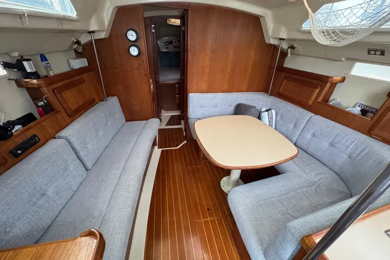 Slide: The Image of Cozy interior of 1992 Hunter 33.5 sailboat with wooden finish and cushioned seating. - 36