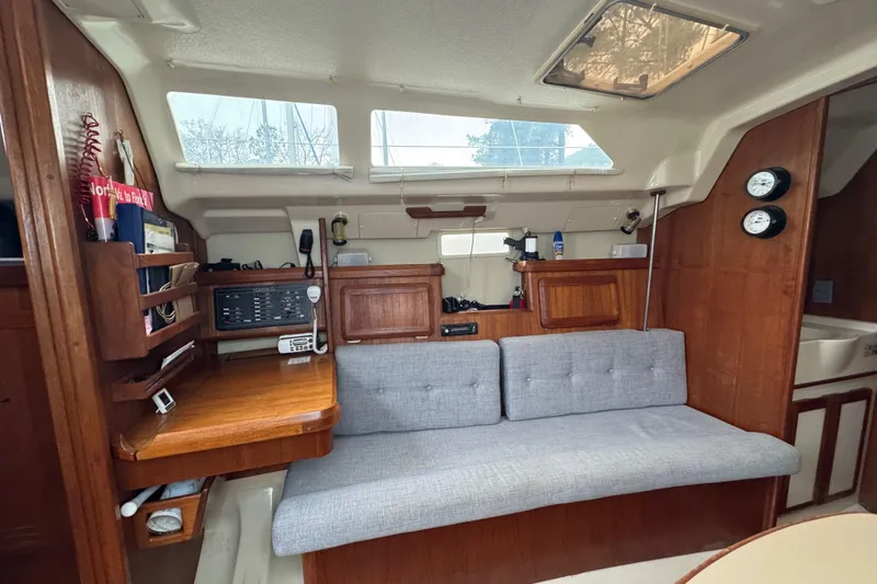 Slide: The Image of Interior of a 1992 Hunter 33.5 sailboat with wooden cabinetry and gray seating. - 37