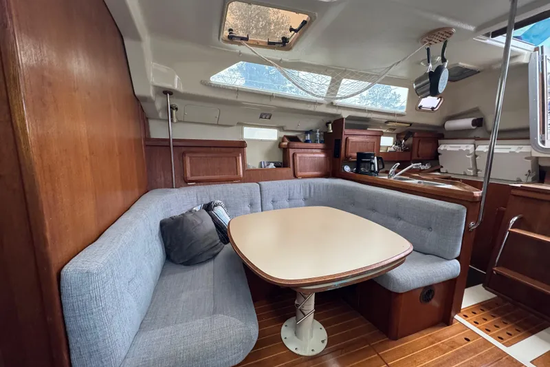 Slide: The Image of Interior of 1992 Hunter 33.5 sailboat with cozy seating and wooden finishes. - 38