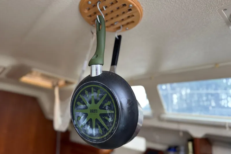 Slide: The Image of Hanging pan inside a 1992 Hunter 33.5 sailboat cabin, showcasing interior design. - 41