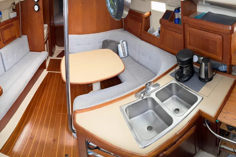 Slide: The Image of Interior of a 1992 Hunter 33.5 sailboat with kitchen and seating area. - 43