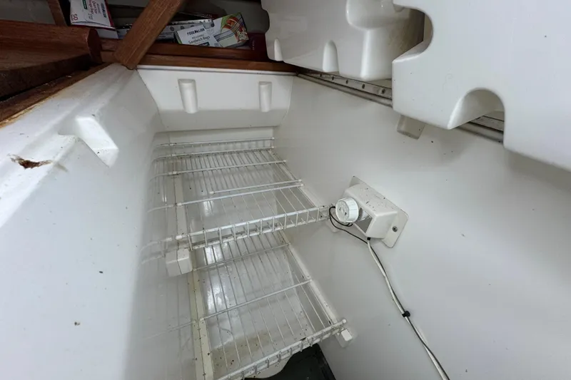 Slide: The Image of Empty refrigerator interior with wire shelves and temperature control, Hunter 33.5, 1992 model. - 46