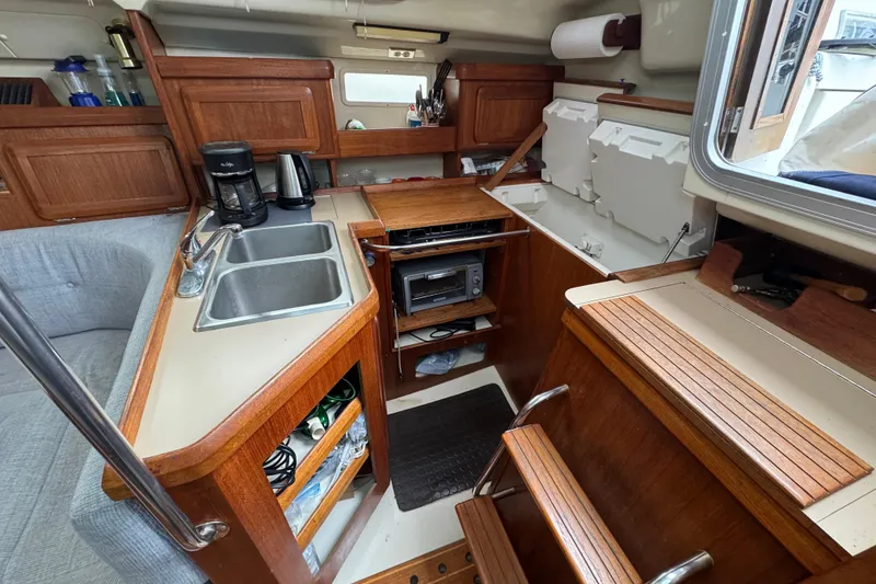 Slide: The Image of Interior of 1992 Hunter 33.5 sailboat kitchen with wood cabinetry and dual sink. - 55