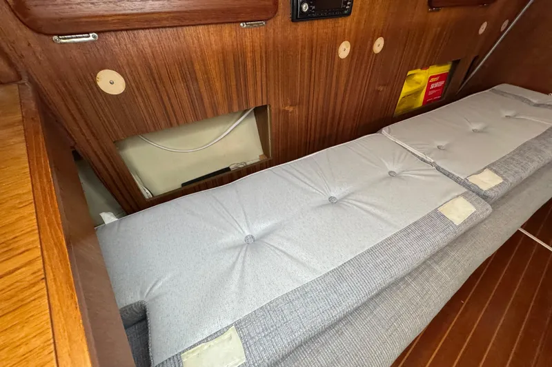 Slide: The Image of Interior of a 1992 Hunter 33.5 sailboat with wooden paneling and cushioned seating. - 56
