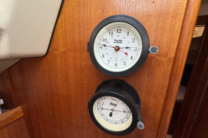 Slide: The Image of Wall-mounted clock and barometer on 1992 Hunter 33.5 sailboat interior. - 57