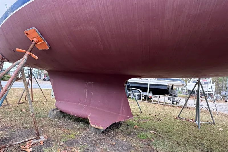 Slide: The Image of 1992 Hunter 33.5 sailboat hull on stands, showing keel and support structure. - 6