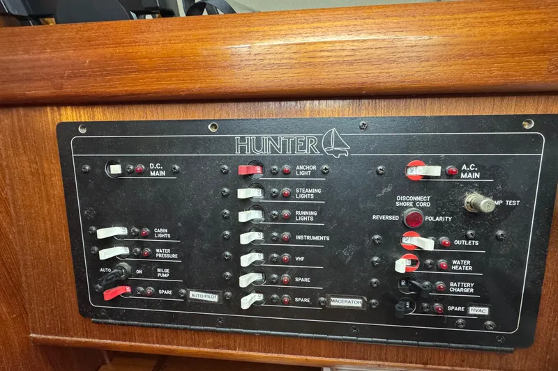 Slide: The Image of Electrical control panel of a 1992 Hunter 33.5 sailboat with various switches and indicators. - 62