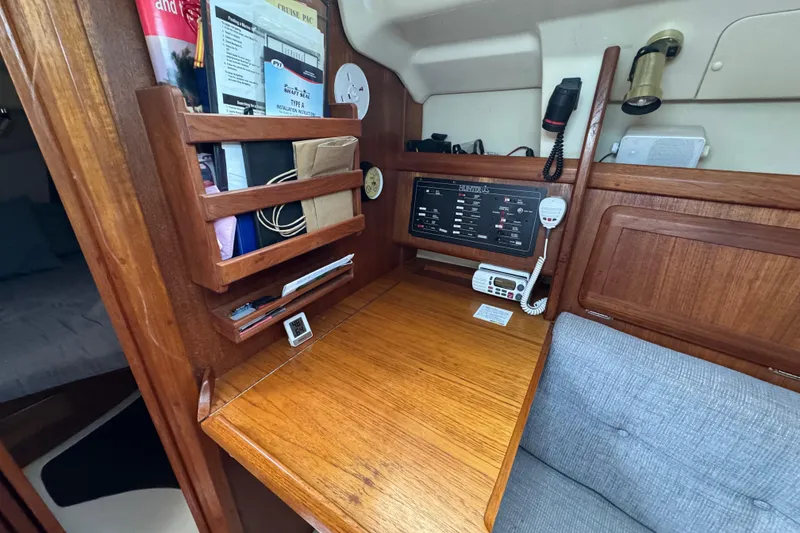 Slide: The Image of 1992 Hunter 33.5 yacht interior with navigation station and wooden cabinetry. - 63