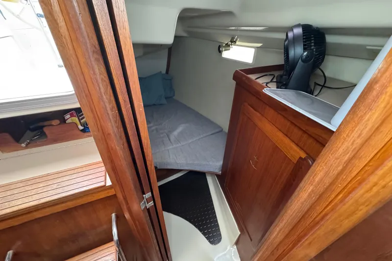 Slide: The Image of Cozy cabin interior of 1992 Hunter 33.5 sailboat with wooden furnishings. - 65
