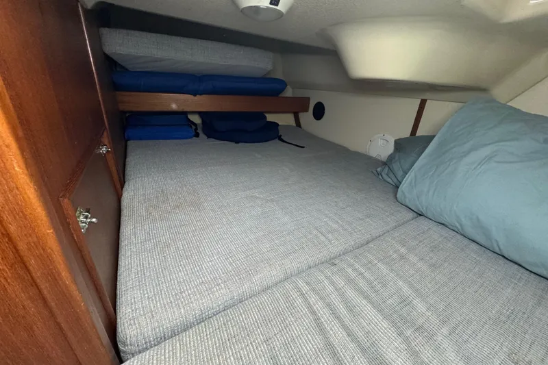Slide: The Image of Cozy cabin interior of 1992 Hunter 33.5 sailboat with comfortable bedding. - 66