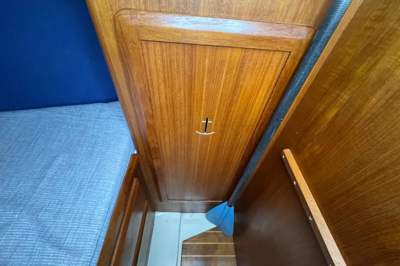 Slide: The Image of Wooden interior of a 1992 Hunter 33.5 sailboat with a blue paddle. - 69