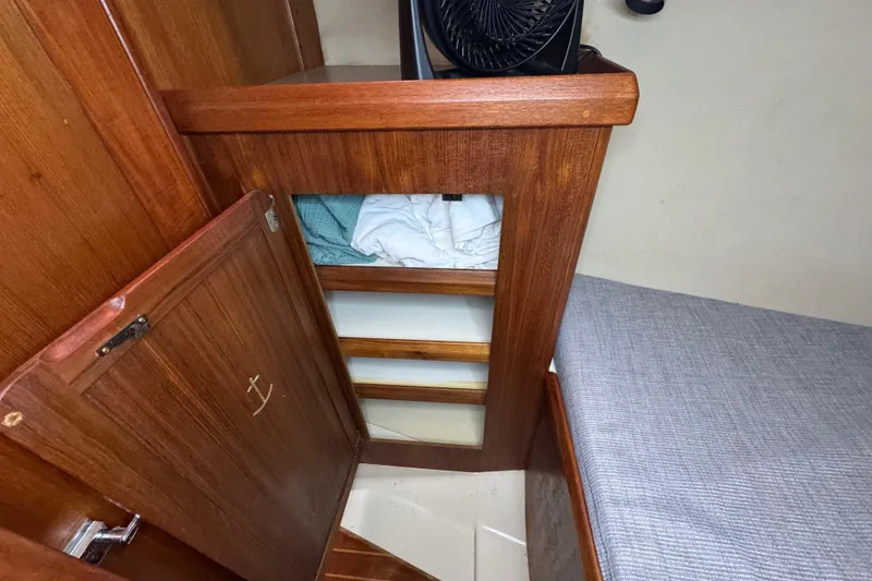 Slide: The Image of Interior of a 1992 Hunter 33.5 sailboat with wooden cabinetry and storage. - 70