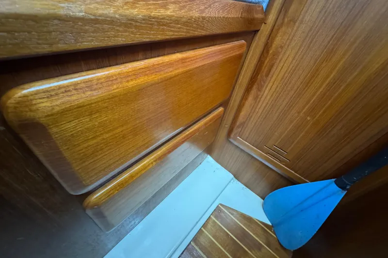 Slide: The Image of Wooden interior of a 1992 Hunter 33.5 sailboat with a blue paddle. - 71