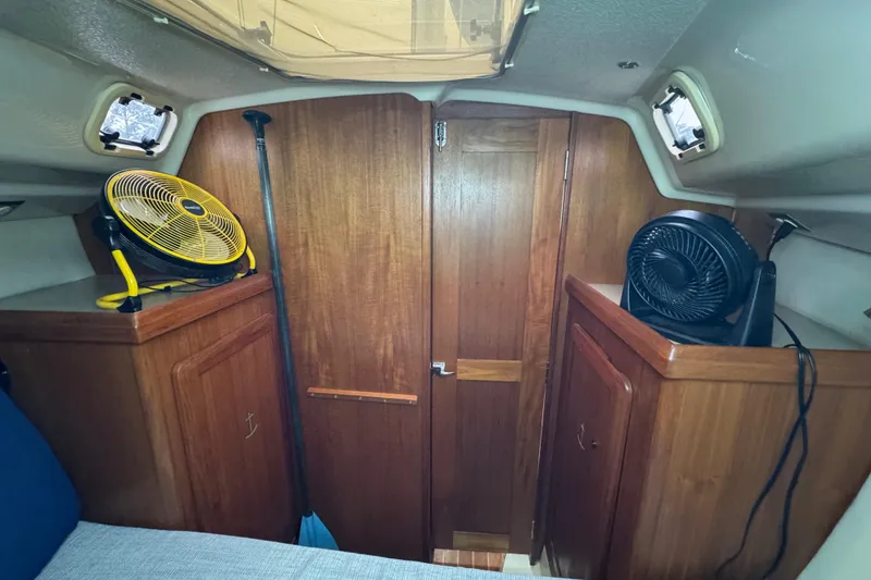 Slide: The Image of Interior of a 1992 Hunter 33.5 sailboat with wooden cabinets and fans. - 72