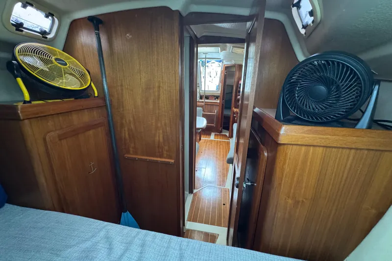 Slide: The Image of Interior of a 1992 Hunter 33.5 sailboat with wooden cabinetry and fans. - 73