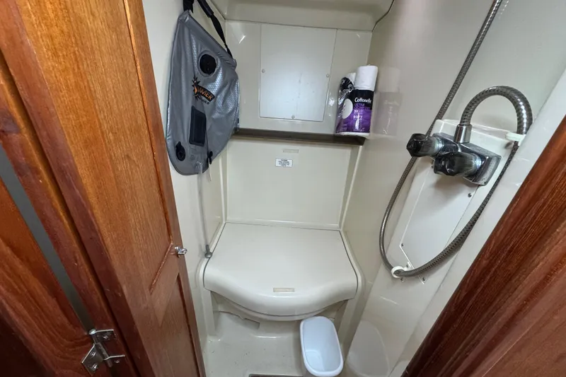 Slide: The Image of Compact bathroom in a 1992 Hunter 33.5 sailboat with shower and storage. - 82