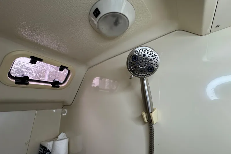 Slide: The Image of Shower area in 1992 Hunter 33.5 yacht with porthole and adjustable showerhead. - 85