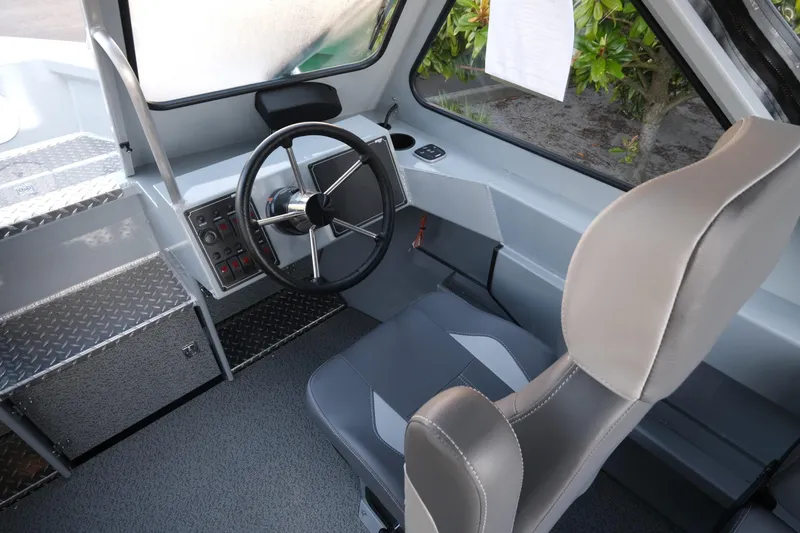 Slide: The Image of Interior of 2025 Hewescraft 190 SeaRunner ET, featuring steering wheel and control panel. - 10