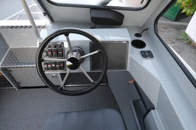 Slide: The Image of Interior view of 2025 Hewescraft 190 SeaRunner ET boat cockpit with steering wheel. - 11