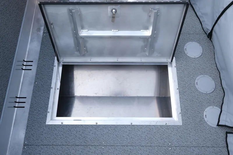 Slide: The Image of Open storage compartment on 2025 Hewescraft 190 SeaRunner ET boat deck. - 12