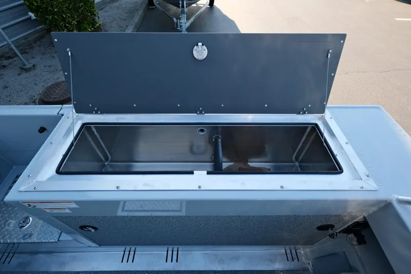 Slide: The Image of 2025 Hewescraft 190 SeaRunner ET boat's open storage compartment, showcasing sleek design and functionality. - 13