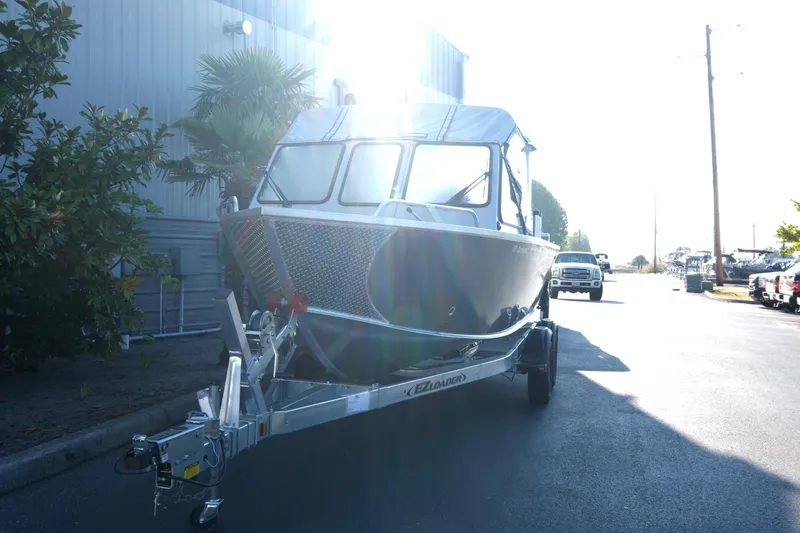 Slide: The Image of 2025 Hewescraft 190 SeaRunner ET boat on trailer, parked outdoors in sunlight. - 3