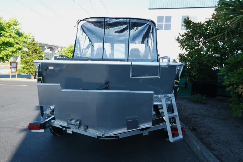 Slide: The Image of 2025 Hewescraft 190 SeaRunner ET boat, rear view, parked outdoors. - 5