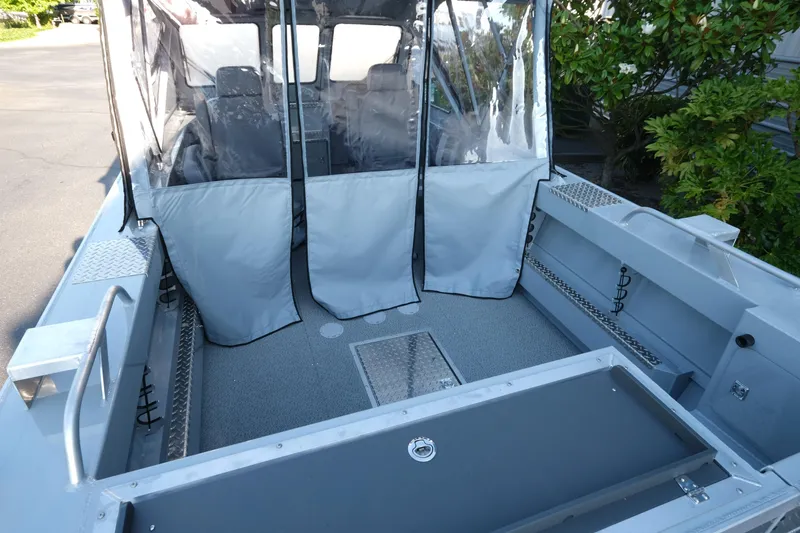 Slide: The Image of 2025 Hewescraft 190 SeaRunner ET boat interior with protective cover and seating. - 6