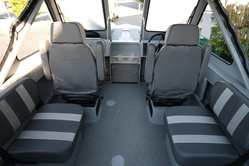 Slide: The Image of Interior of 2025 Hewescraft 190 SeaRunner ET boat with gray seating and steering console. - 7