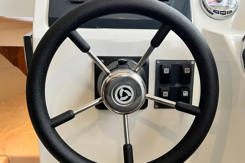Slide: The Image of Steering wheel of 2023 Parker Poland Skamander boat with control panel. - 12