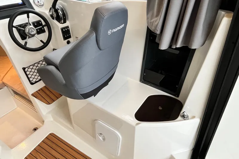 Slide: The Image of 2023 Parker Poland Skamander boat interior with steering wheel and captain's seat. - 16
