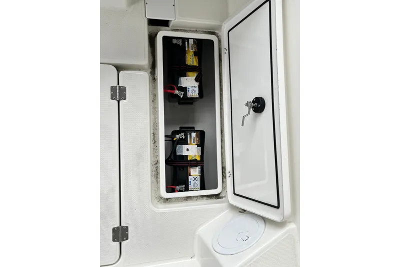 Slide: The Image of Battery compartment of 2023 Parker Poland Skamander boat, featuring secure storage and wiring. - 18
