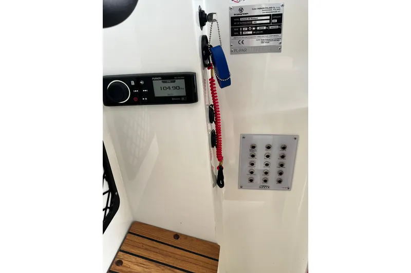 Slide: The Image of Control panel of 2023 Parker Poland Skamander boat with radio and switches. - 19