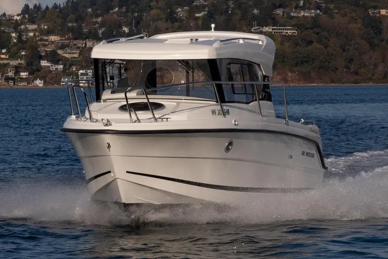 Slide: The Image of 2023 Parker Poland Skamander boat cruising on a scenic lake. - 2