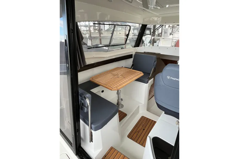 Slide: The Image of 2023 Parker Poland Skamander boat interior with seating and wooden table. - 22
