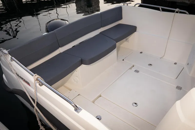 Slide: The Image of 2023 Parker Poland Skamander boat interior with cushioned seating and storage compartments. - 7