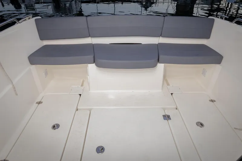 Slide: The Image of 2023 Parker Poland Skamander boat interior with cushioned seating and storage compartments. - 8