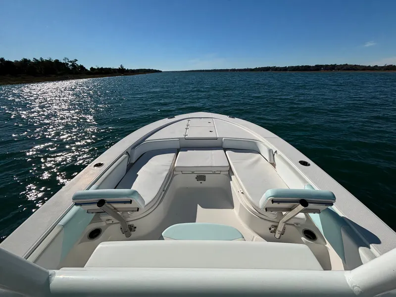 Slide: The Image of 2018 Robalo 246 Cayman boat on open water under sunny skies. - 12