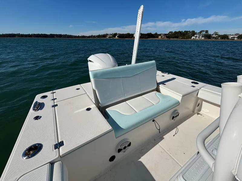 Slide: The Image of 2018 Robalo 246 Cayman on calm water with seating bench. - 23