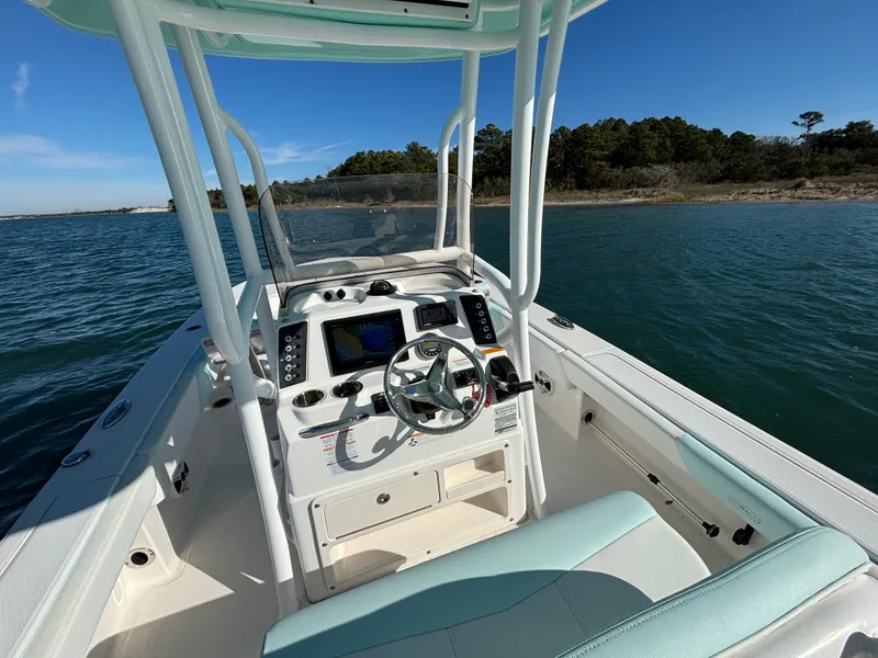 Slide: The Image of Interior view of a 2018 Robalo 246 Cayman boat on the water. - 25