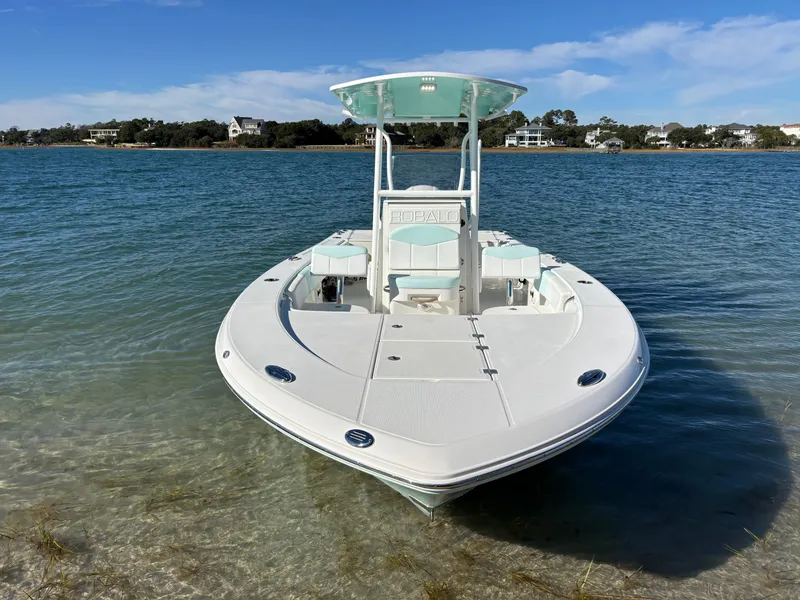 Slide: The Image of 2018 Robalo 246 Cayman boat anchored in clear water. - 3